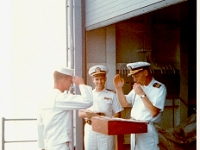 Promotional ceremony on the hanger deck. Hanger for what? Keep going.  Promotions at sea.
